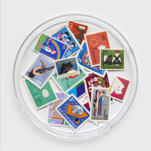 Assorted global stamps in a glass dish